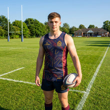 Load image into Gallery viewer, Trinity Guild Rugby Club training vest on a model, standing on a rugby pitch.
