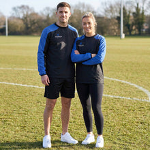 Load image into Gallery viewer, Two people standing on a grassy field wearing Scorpion Sports Drill Tops, standing on a sports field.
