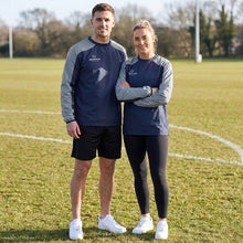 Load image into Gallery viewer, Two people standing on a grassy field wearing matching Scorpion Sports Pro Drill Tops in navy and grey.
