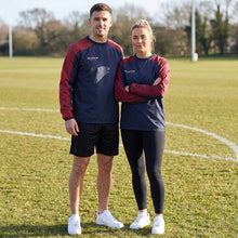 Load image into Gallery viewer, Two people standing on a sports field wearing matching navy and maroon Scorpion Sports Pro Drill Tops.

